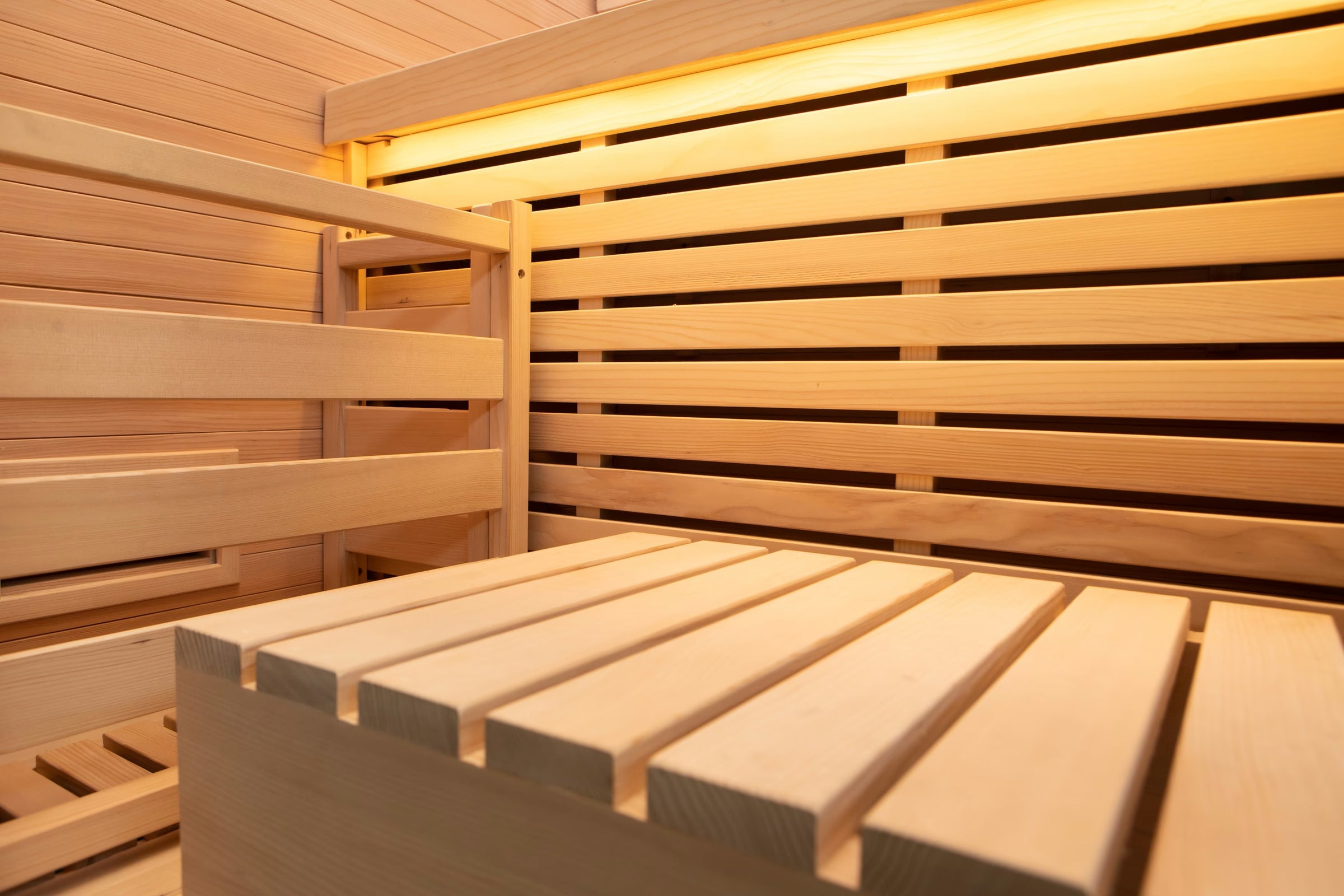 Canadian Hemlock bench and backrest inside the Forge Indoor, lit from below